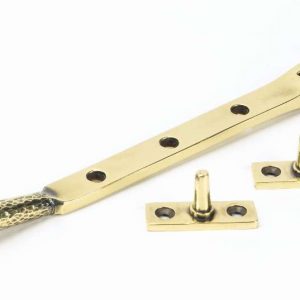 From the Anvil Aged Brass 8" Hammered Newbury Stay - 46144
